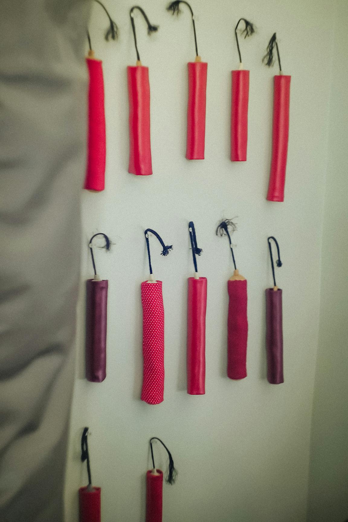 A wall is hung with many fake sticks of dynamite.